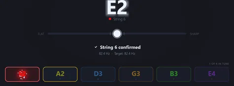 Five of six strings already in tune, the sixth just confirmed under a string lock.